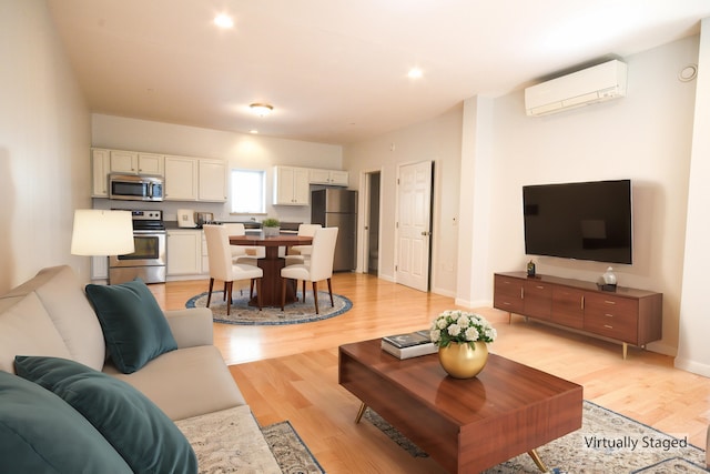 living room with light wood-type flooring and a wall mounted AC