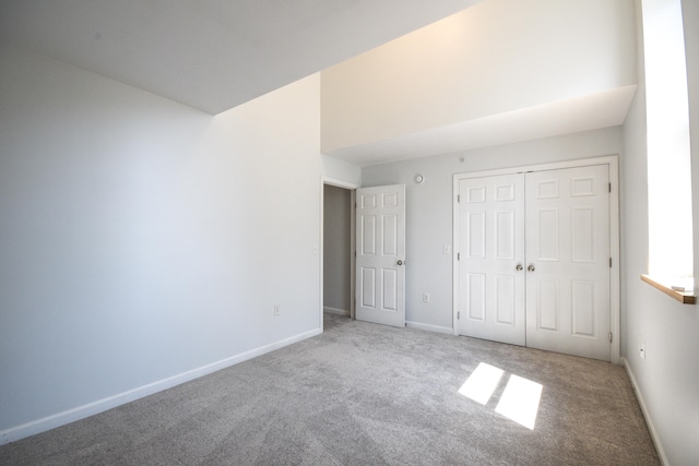 unfurnished bedroom with carpet flooring and a closet