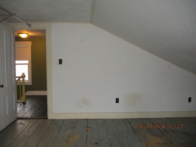 bonus room with dark hardwood / wood-style floors and lofted ceiling