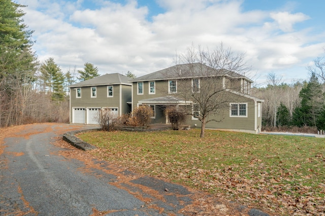 view of front of house with a garage and a front lawn