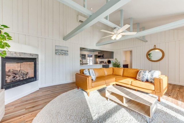 living room featuring beam ceiling, ceiling fan, light hardwood / wood-style flooring, and high vaulted ceiling