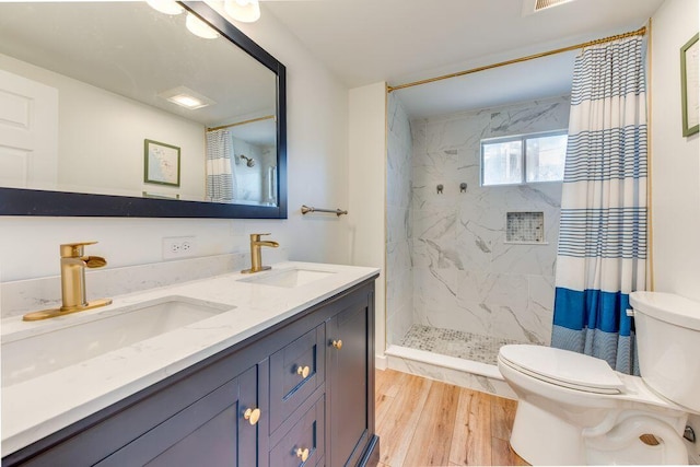 bathroom featuring toilet, hardwood / wood-style floors, vanity, and a shower with shower curtain