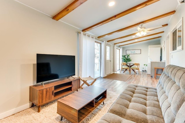 living room with light wood-type flooring, lofted ceiling with beams, and ceiling fan