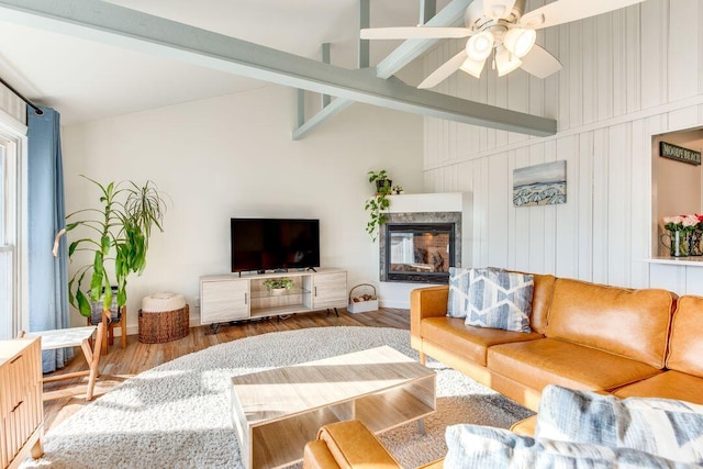 living room featuring hardwood / wood-style floors, lofted ceiling with beams, and ceiling fan