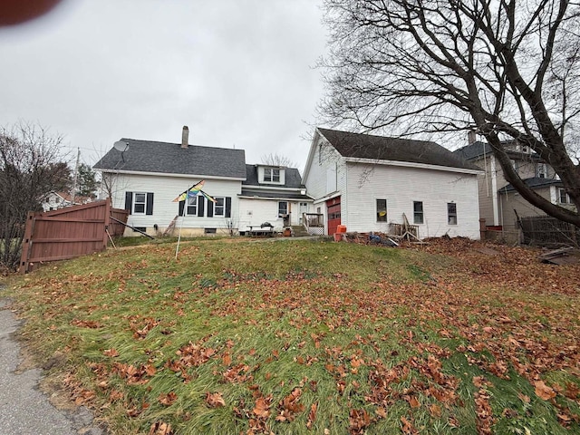 rear view of property featuring a yard