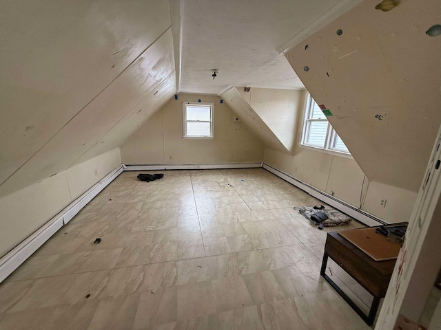 additional living space with lofted ceiling and a baseboard heating unit