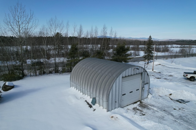 exterior space with a garage and an outdoor structure