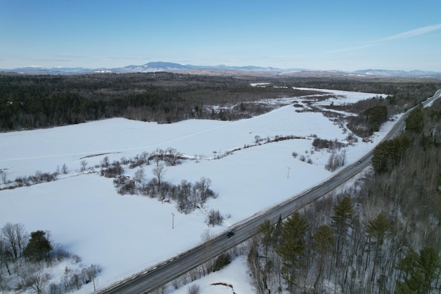 snowy aerial view featuring a mountain view