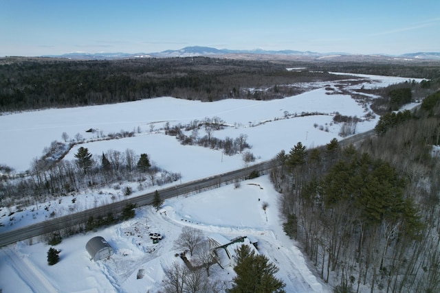 snowy aerial view featuring a mountain view