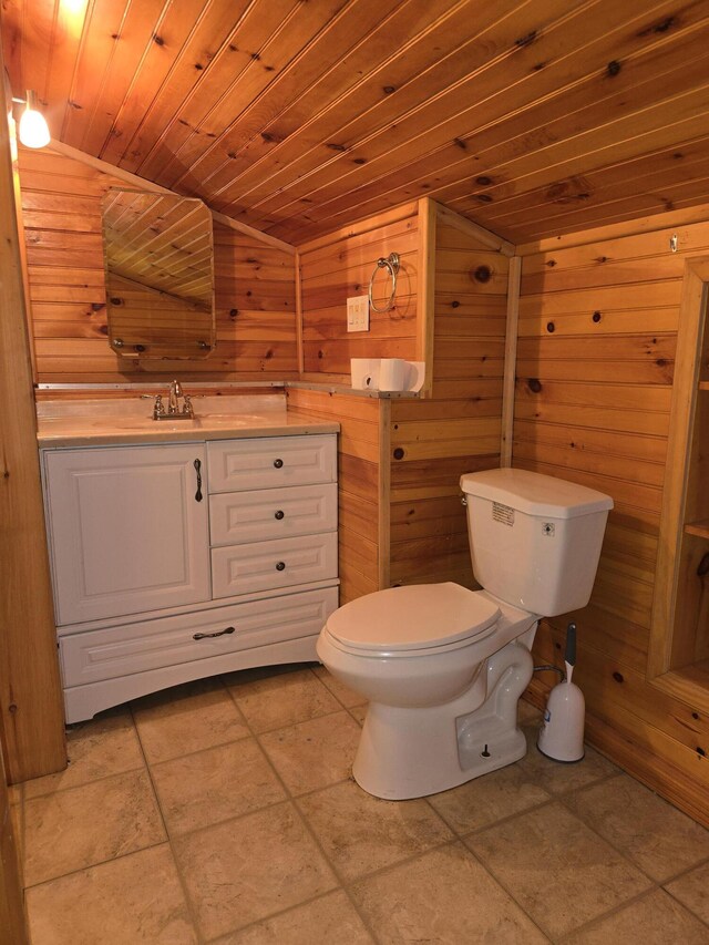 bathroom with vanity, wooden ceiling, wooden walls, and toilet