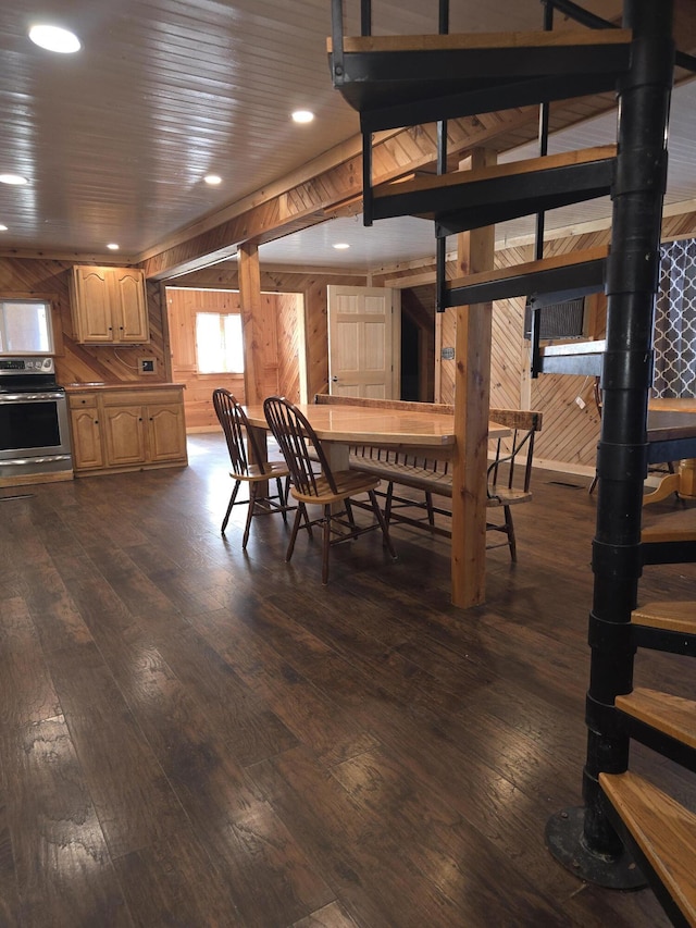 dining area featuring dark wood-style floors, wooden walls, and recessed lighting