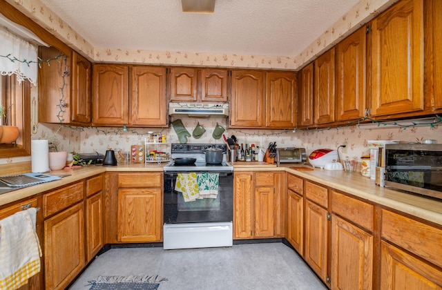kitchen with a textured ceiling and electric stove