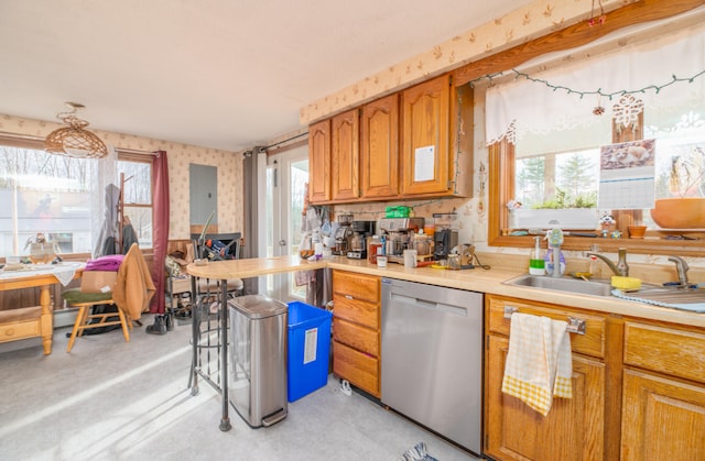 kitchen featuring stainless steel dishwasher, a healthy amount of sunlight, and sink