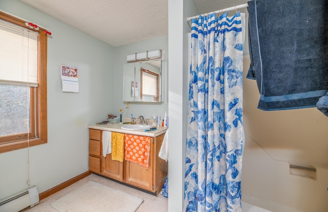 bathroom featuring vanity, a textured ceiling, and a baseboard radiator