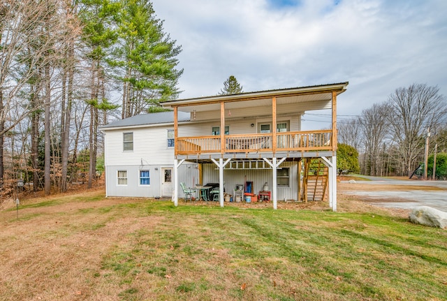 back of house featuring a yard and a wooden deck