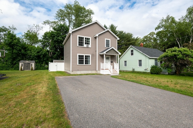 view of front facade featuring a front lawn and a storage unit