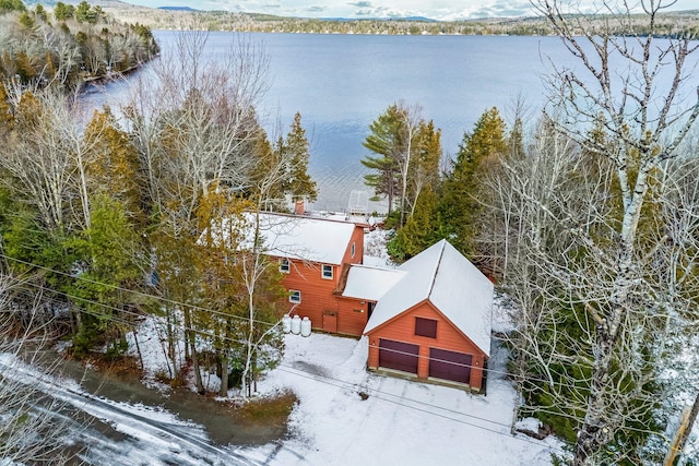 snowy aerial view featuring a water view