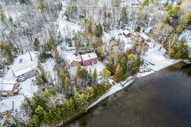 snowy aerial view with a water view