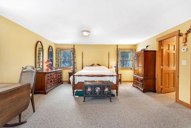 bedroom featuring multiple windows and light carpet