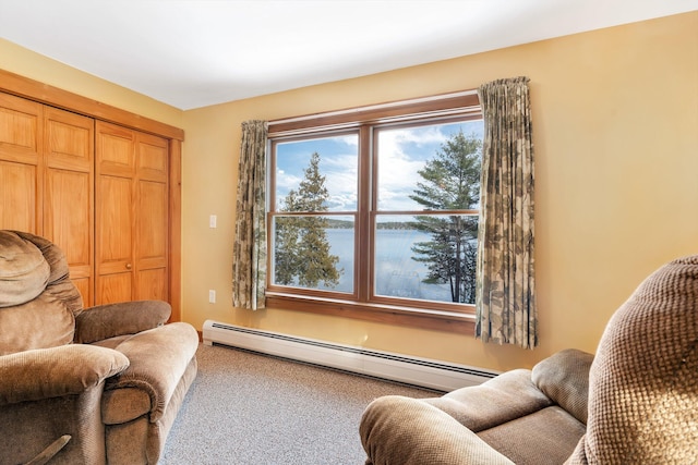 living area featuring a water view, baseboard heating, and carpet