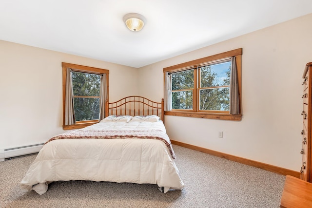 carpeted bedroom with baseboard heating and multiple windows