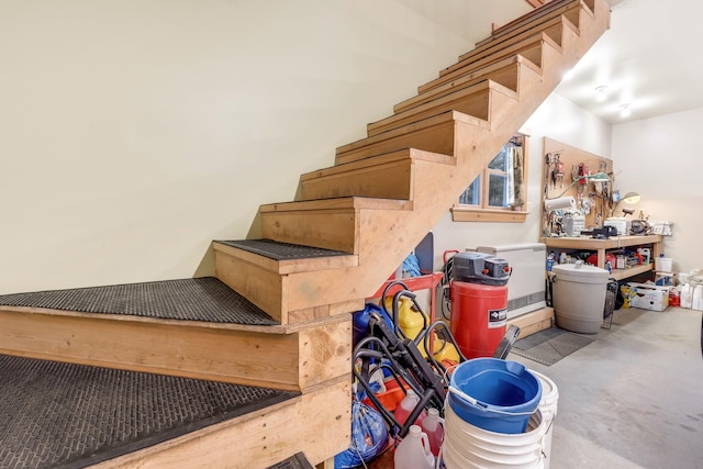 stairway featuring concrete flooring