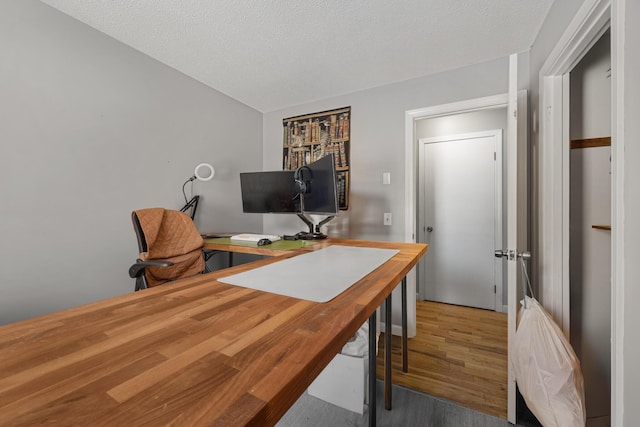 office space featuring a textured ceiling and hardwood / wood-style floors