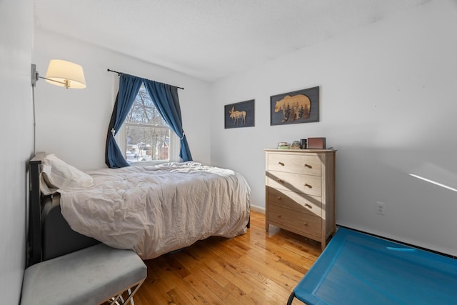 bedroom with wood-type flooring