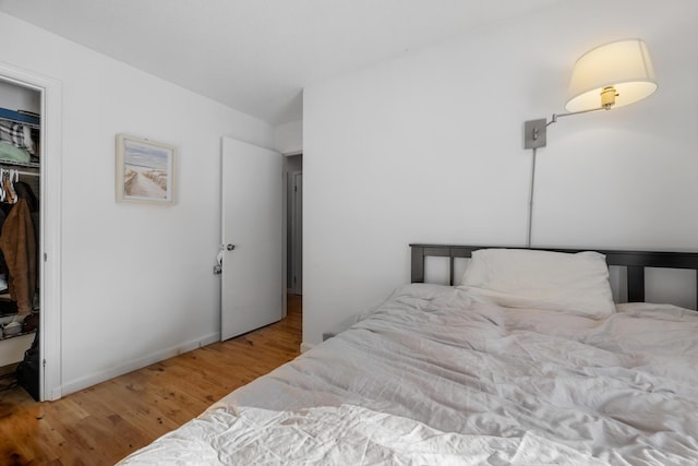 bedroom with a closet and hardwood / wood-style floors