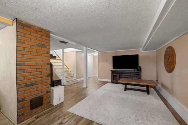 interior space with a textured ceiling and light hardwood / wood-style flooring