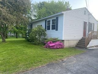 view of property exterior with a lawn