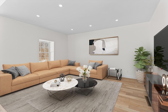 living area featuring recessed lighting, baseboards, visible vents, and light wood finished floors