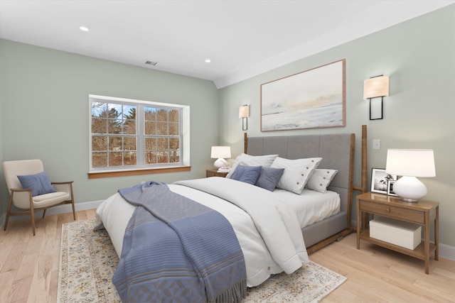 bedroom with light wood-type flooring, visible vents, baseboards, and recessed lighting