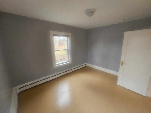 spare room with light hardwood / wood-style floors and baseboard heating