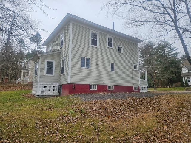 view of property exterior with a lawn