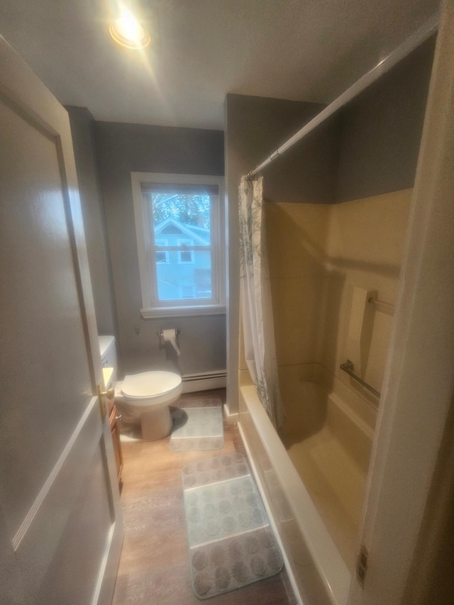 bathroom featuring toilet and a baseboard heating unit