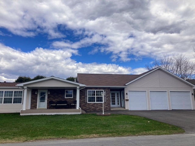 single story home with covered porch, a garage, and a front lawn