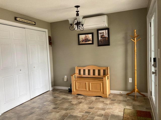 interior space featuring a wall unit AC and a chandelier