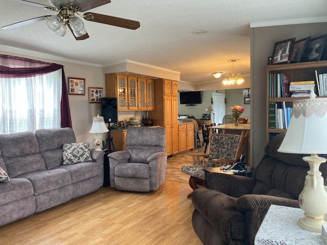 living room with ceiling fan with notable chandelier, light hardwood / wood-style floors, and ornamental molding