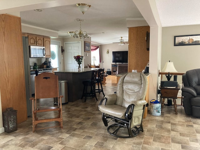 interior space with ceiling fan with notable chandelier and ornamental molding