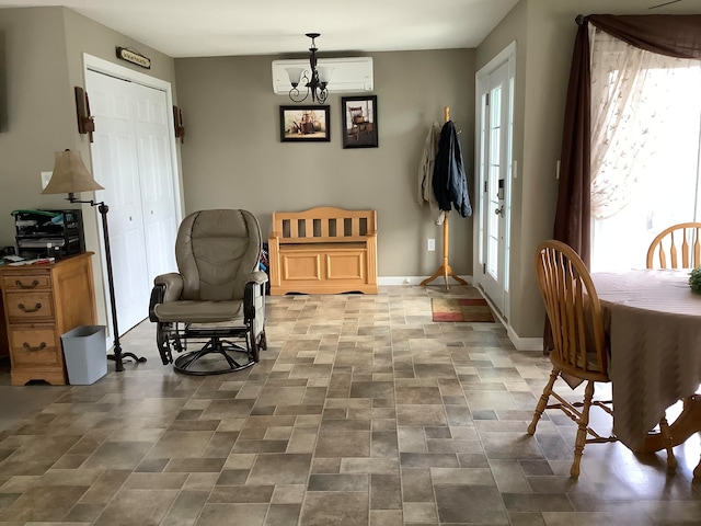 living area with a wall mounted AC and an inviting chandelier