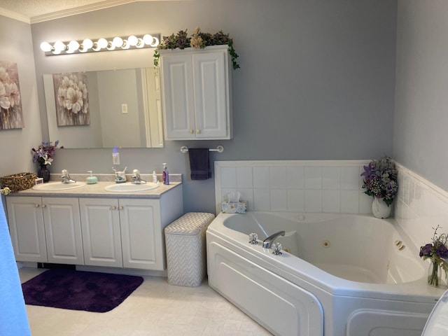 bathroom featuring crown molding, a washtub, and vanity