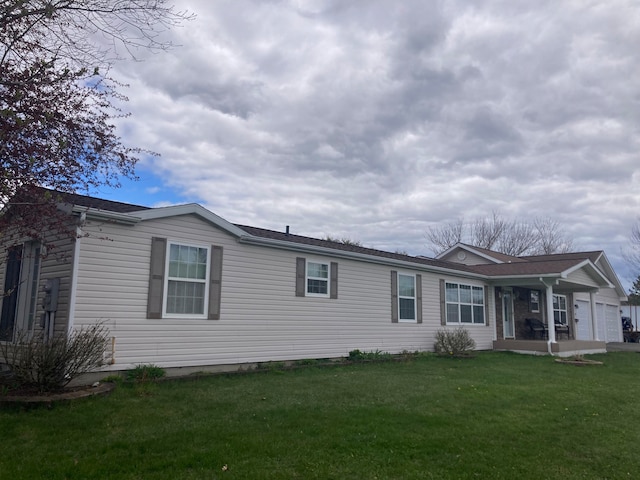 exterior space featuring a yard and a garage