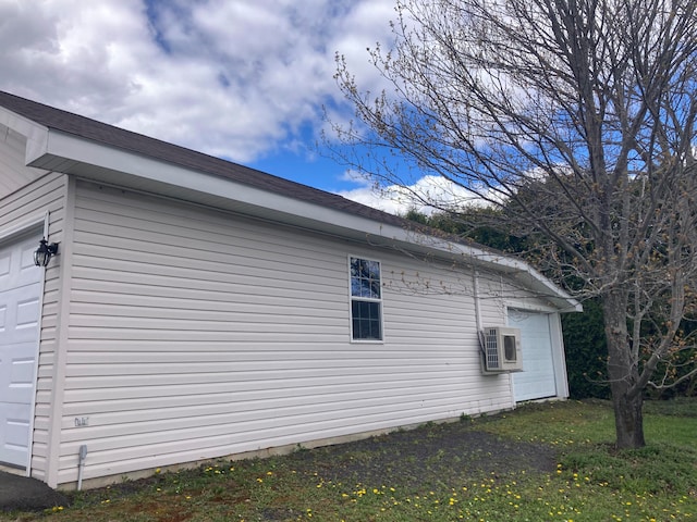 view of side of property featuring ac unit and a garage