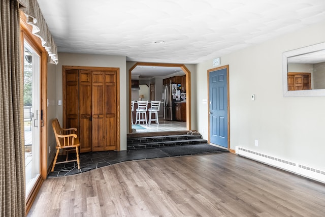 entryway featuring hardwood / wood-style floors and baseboard heating