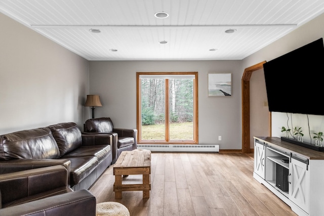 living room featuring light hardwood / wood-style flooring and a baseboard heating unit