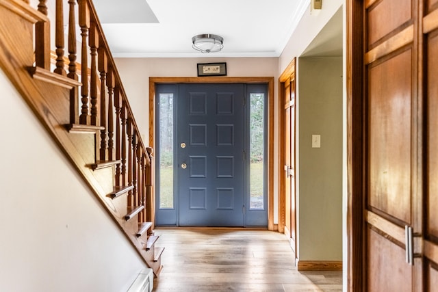 entryway featuring light hardwood / wood-style floors and ornamental molding