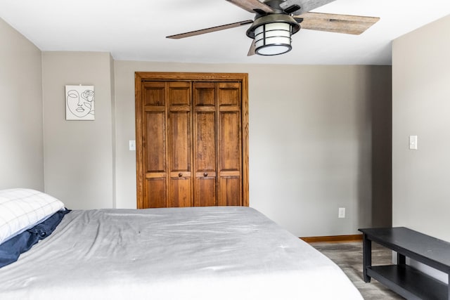 bedroom featuring ceiling fan, a closet, and hardwood / wood-style flooring