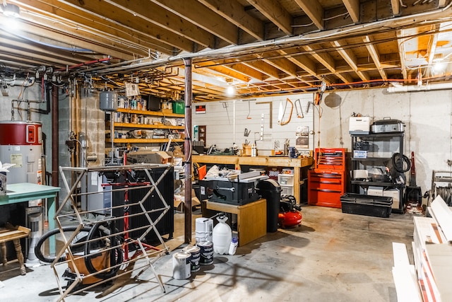 basement with a workshop area and electric water heater