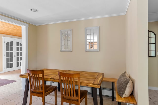 tiled dining room with crown molding and french doors